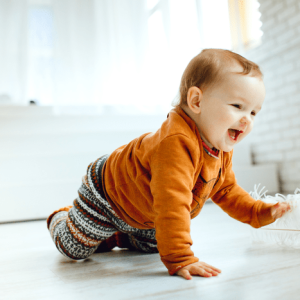happy-child-orange-sweater-plays-with-feather-floor (2) happy-child-orange-sweater-plays-with-feather-floor (2)